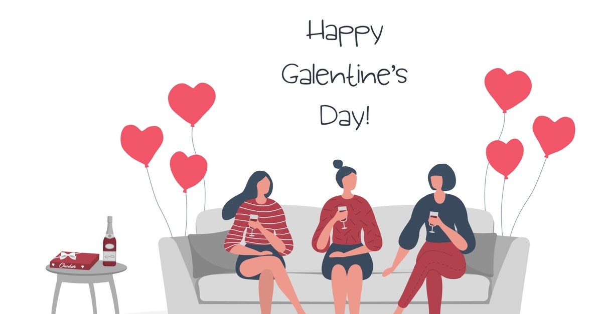 young women are sitting on the sofa and drinking wine