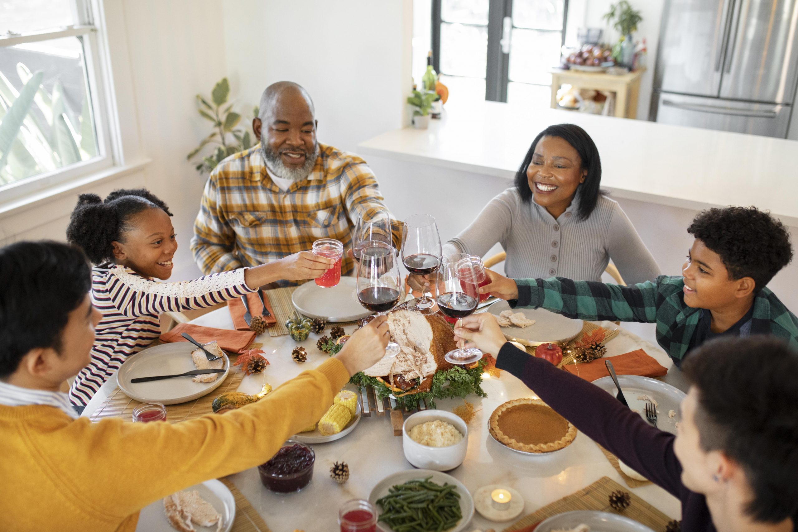 family giving thanksgiving toast