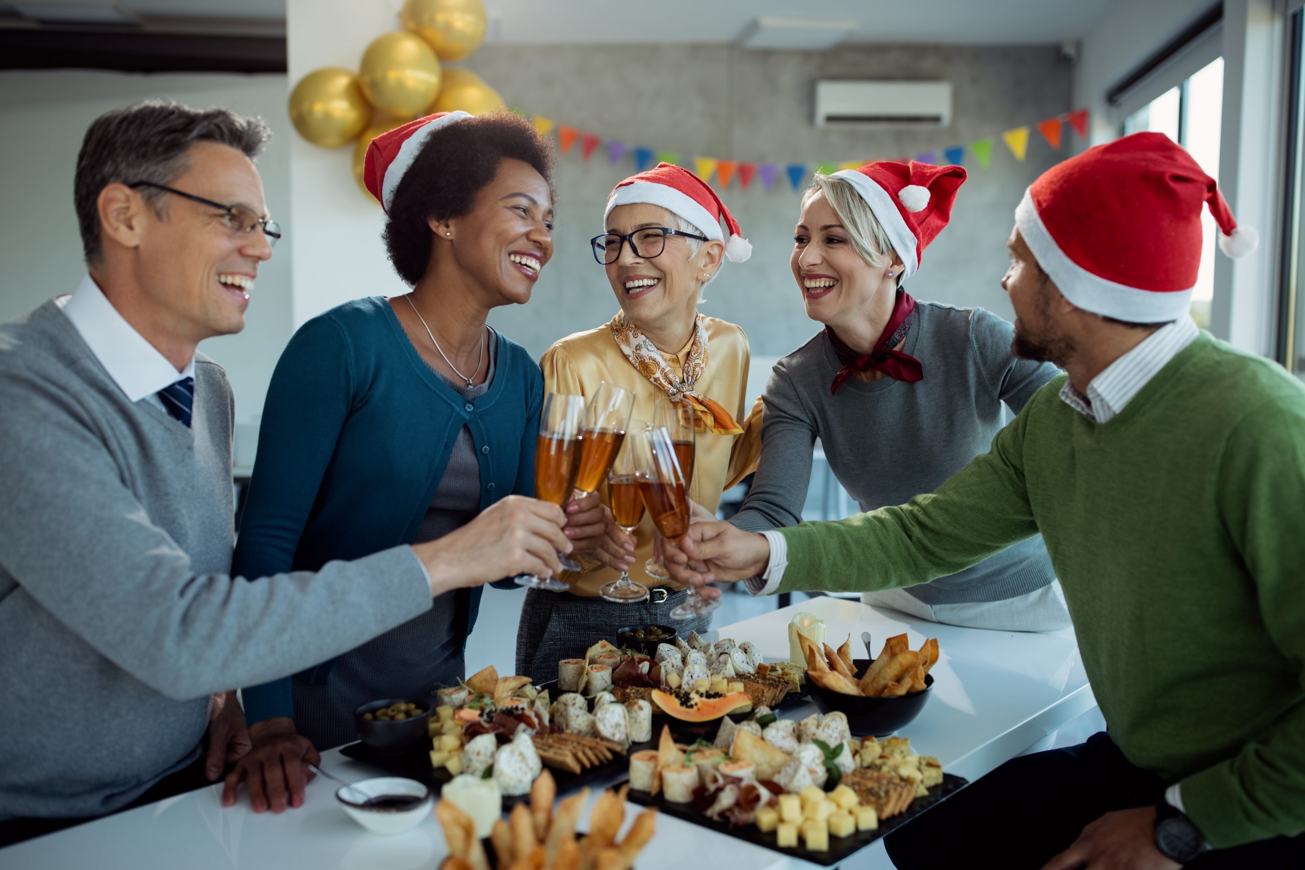 Happy business team toasting with Champagne on Christmas